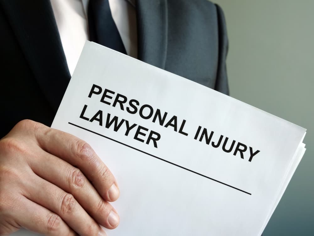 A personal injury lawyer holding a clipboard and legal documents.