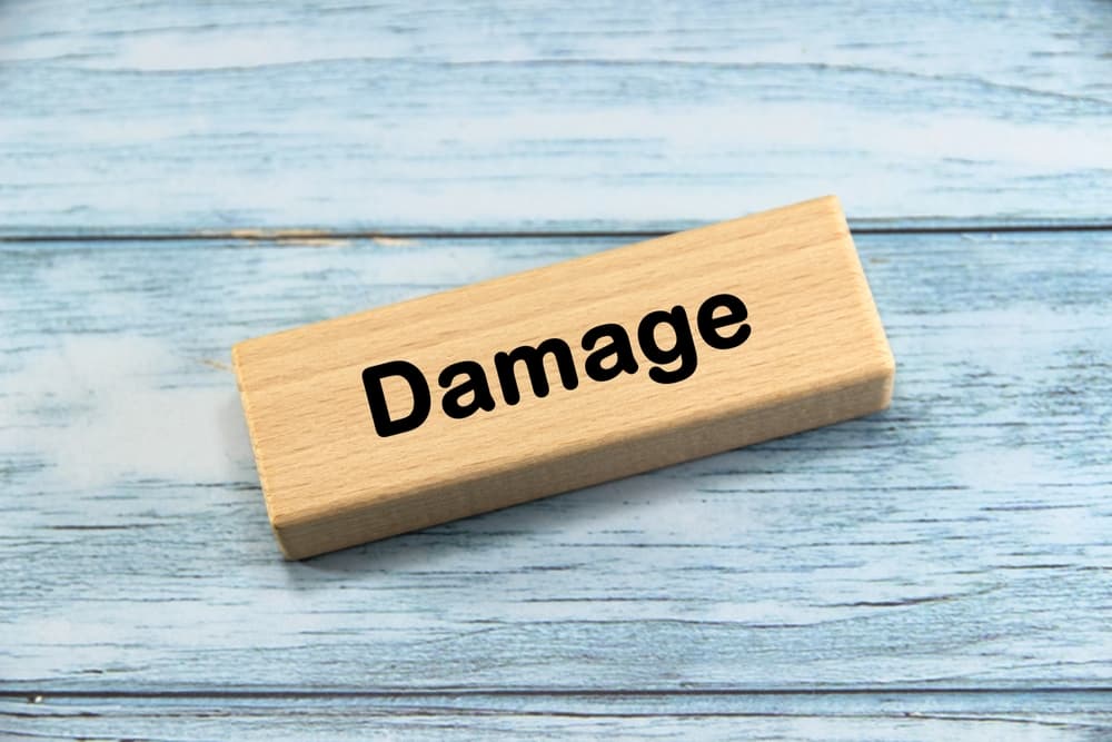 Damage written on wooden block