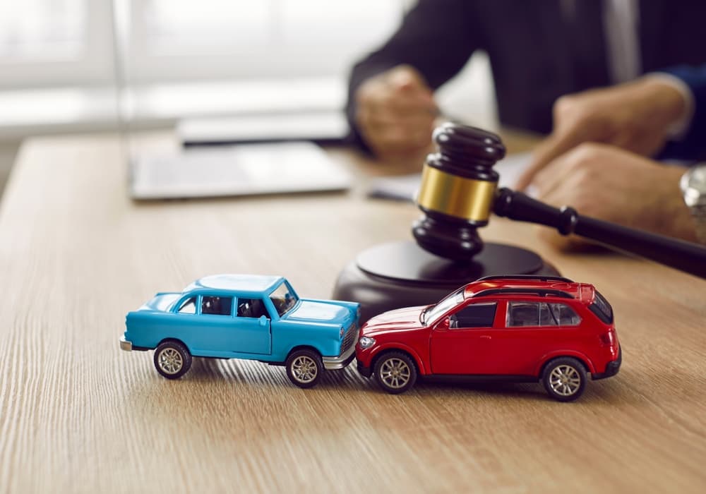 Little crashed autos on table in courtroom. 