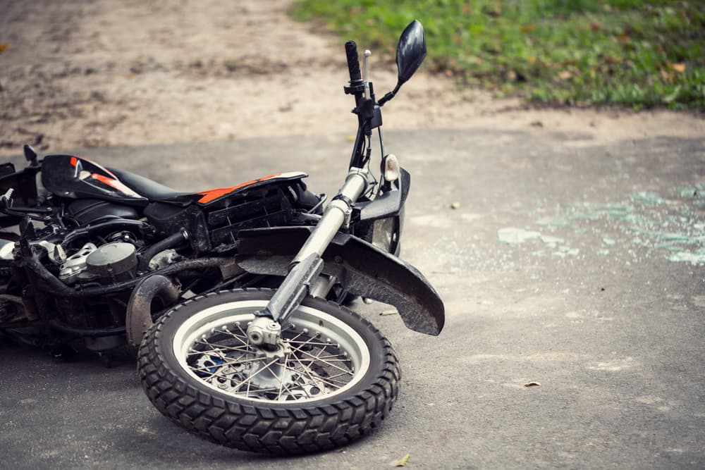 Damaged motorcycle lying on the road following a traffic accident.






