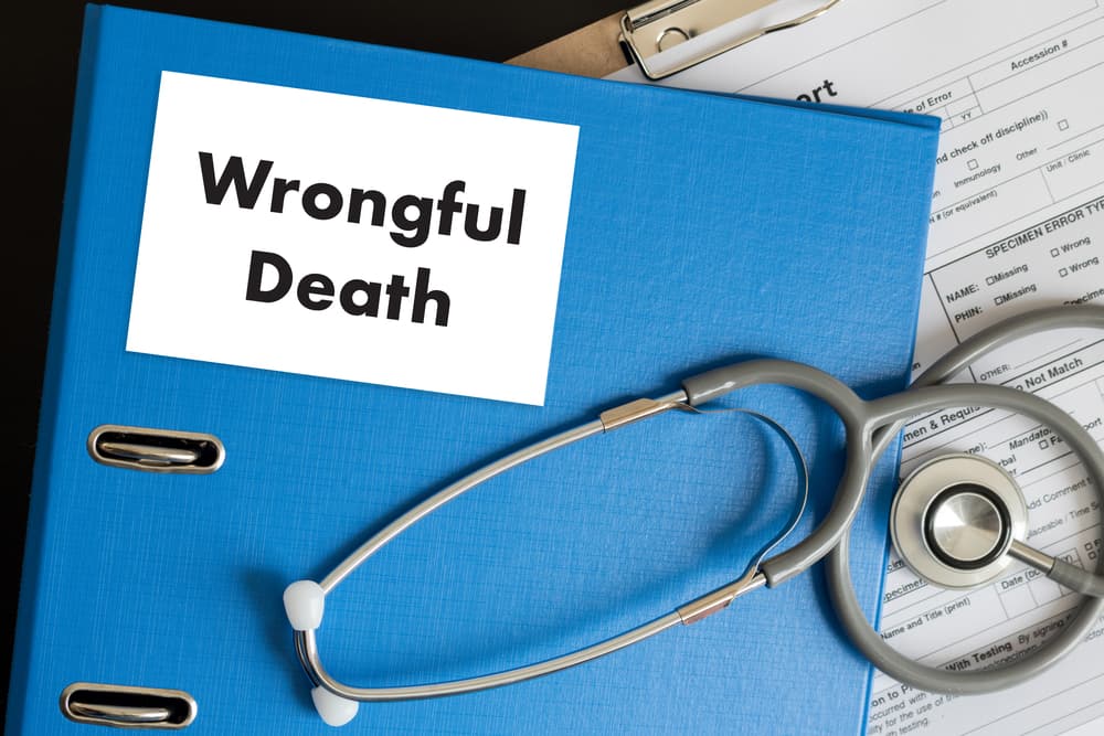 A doctor discusses a wrongful death case with a patient in a medical office, reviewing medical details and providing necessary information for legal purposes.