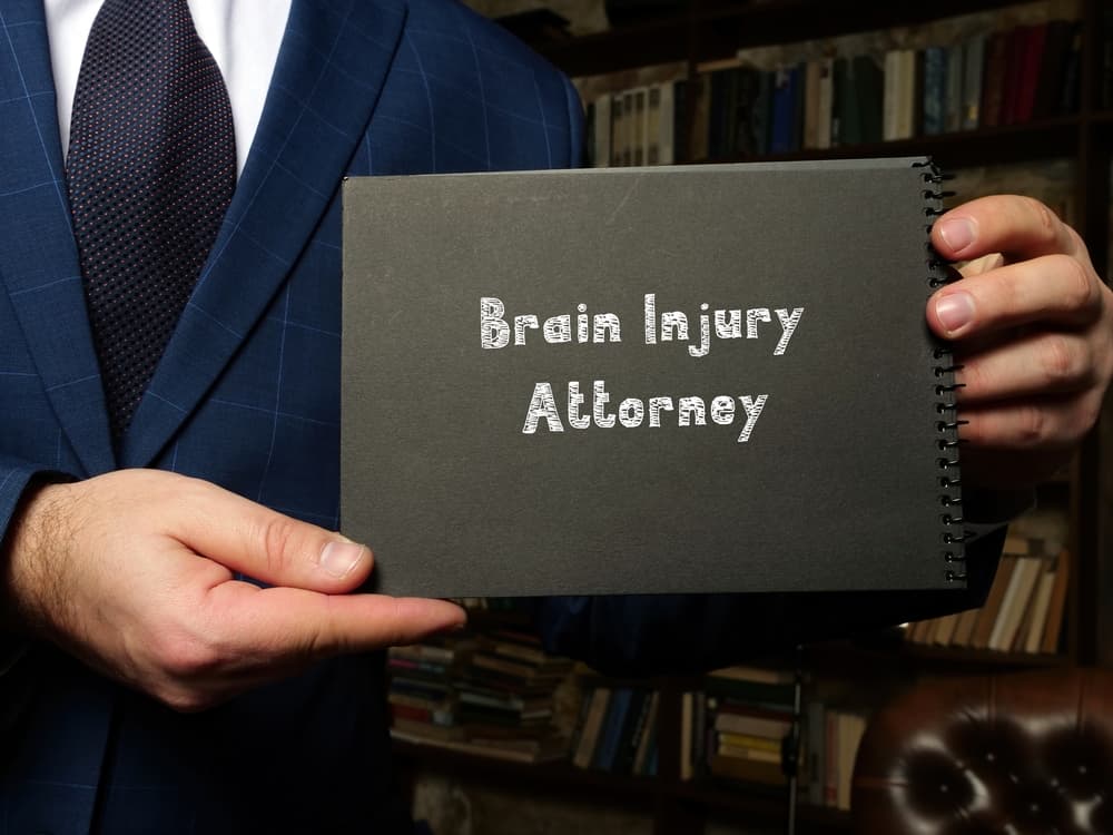 A sheet of paper with the inscription "Brain Injury Attorney" written in bold, clear letters. The text stands out prominently, emphasizing legal representation for brain injury cases. 