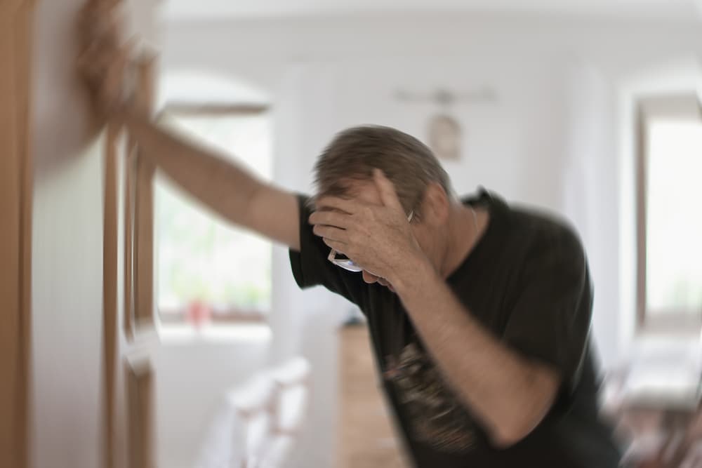 A blurred photo of a man experiencing vertigo, dizziness, or an inner ear or brain-related health issue.